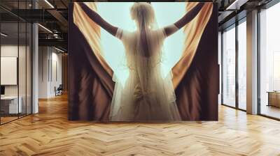 Beautiful bride standing near window. The girl in a white wedding dress. Wall mural