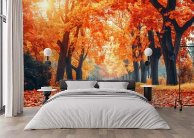 A leafy autumn alley with tall trees with vibrant orange and yellow foliage and a bright setting sun Wall mural