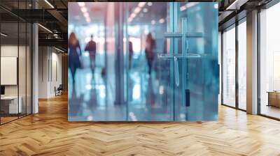 An office with a white glass background and blurred business people. Wall mural