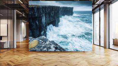 Dramatic skies and majestic waves crashing against rugged cliffs Wall mural