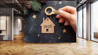 Keychain cottage on festive black background with stars and garlands. New Year 2025 wooden letters. Purchase, construction, relocation, mortgage, insurance. Wall mural