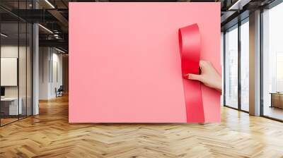 Presented to a woman is a sex gift vibrator wrapped in paper in her hand. Wall mural