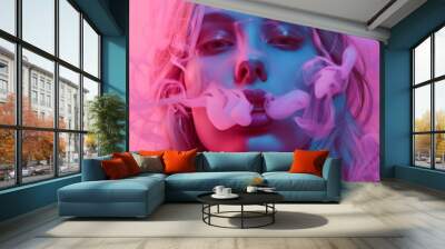 Stock photo of a beautiful woman isolated on pink smoke background. Wall mural