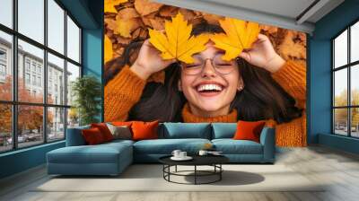 Teenager lying in a field of fallen leaves at the end of autumn season. Concept calm and peace. Caucasian guy in the park on a sunny day with fallen wedge leaves. Photo banner. Wall mural