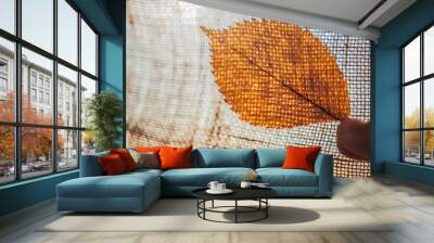 autumn brown elm leaf on sunny sackcloth background. Wall mural