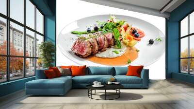 Delicious medium rare meat steak with sauce and salad on a plate. Healthy food made of meat fillet and fresh herbs isolated on a white background. Wall mural