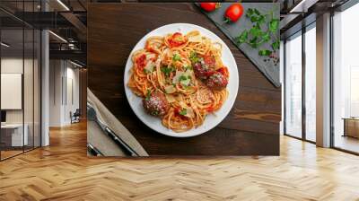 Delicious spaghetti pasta with meatballs and tomato sauce on a plate. Traditional American Italian food on a rustic wooden table. Top view shot directly above. Wall mural