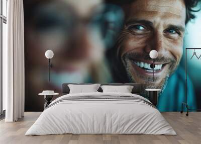 A cheerful man with a broad smile in casual attire, clearly enjoying a happy moment, which signifies positivity, charisma, and life appreciation in contemporary setting. Wall mural