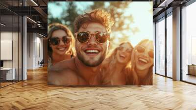 A fun-loving group of four friends wearing summer attire and sunglasses bask in the warm, sunlit garden, embracing a vibrant and carefree atmosphere together. Wall mural