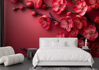 A stunning photograph of pink cherry blossoms in full bloom, delicately arranged against a vibrant red background, showcasing nature's exquisite beauty and detail. Wall mural