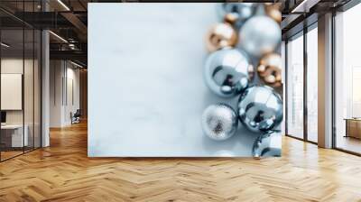 Diverse metal spheres, in silver, gold, and copper tones, organized aesthetically on a smooth surface, reflecting light to create a dynamic, elegant interplay. Wall mural