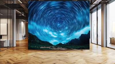 Star trails circle the night sky above rugged mountains, creating an awe-inspiring visual of movement and nature's rhythm set against a dark celestial backdrop. Wall mural