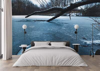 Cracks on the surface of the blue ice. Frozen lake in winter mountains landscape Wall mural