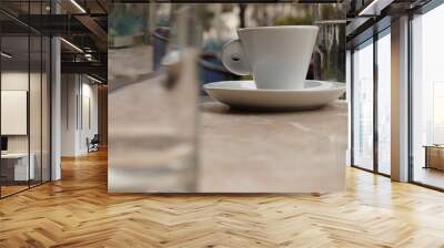 Espresso cup between two glasses on a marble table in a cafe Wall mural