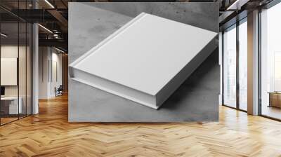 Blank white book on textured gray surface. Suitable for book mockups, stationery designs Wall mural