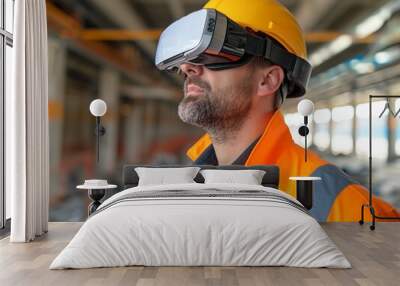 A man wearing a yellow safety helmet and orange vest is looking at a virtual reality headset. Concept of excitement and anticipation as the man prepares to experience the virtual world Wall mural