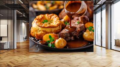 A plate of food with gravy poured over it. The plate has a meat dish and potatoes Wall mural