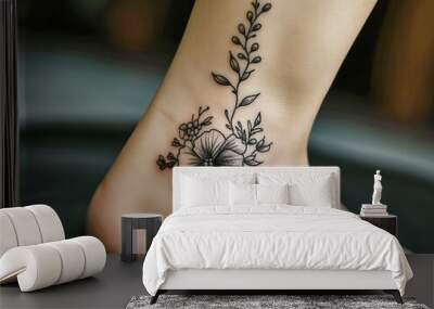 A woman's foot has a flower tattoo on it Wall mural