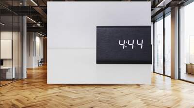 Black digital clock on a white background showing time 4:44 Wall mural