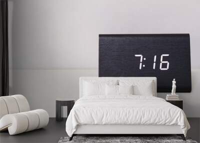 Black digital clock on a white background showing time 7:16 Wall mural