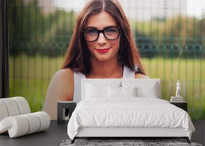 Portrait Of Young Woman Wearing Glasses On Playground Wall mural