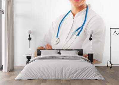 Smiling Attractive Woman doctor with arms crossed stands over wh Wall mural