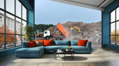 Dump truck unloading old concrete and asphalt from demolition for recycling. Landfill for disposal of construction waste. Gravel and concrete crushing. Salvaging, removal building materials Wall mural