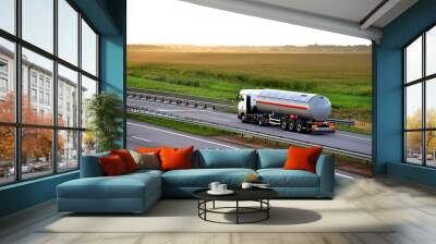 Tank truck driving on highway. Transportation of liquid goods. Metal chrome cistern tanker with petrochemicals products. Oil and Gas logistics. Out of focus, possible granularity, motion blur Wall mural