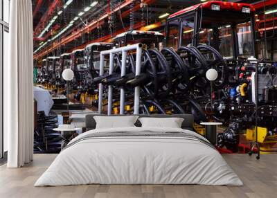 Tractor Manufacture work. Assembly line inside the agricultural machinery factory. Installation of parts on the tractor body - Image Wall mural