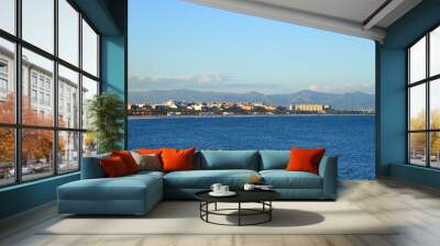 View on coastline and beach from La Marina de Valencia on the sea to the Las Arenas beach, Playa de las Arenas, Platja del Cabanyal and Playa de la Malvarrosa. Waves at sea on blue sky background. Wall mural