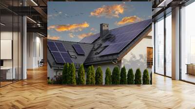 modern house with blue solar panels on the roof. end of the day, sunset. idyllic atmosphere. Wall mural