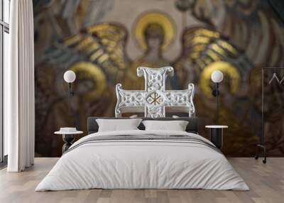 Beautiful white carved marble Orthodox cross on the background of a mosaic panel Wall mural