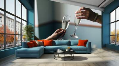 two glasses clinking together after a toast and cheers Wall mural