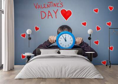 boy covered his face with a clock time of valentine's day celebr Wall mural