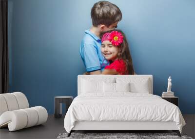 teen girl hugging a teenage boy on gray background Wall mural