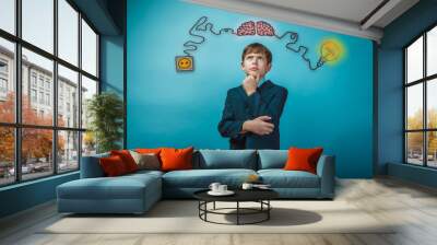 teenage boy thinking thoughtful hand to face the charge of initi Wall mural