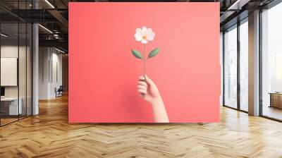 A minimalist illustration of a hand holding a flower, representing the connection between nature and healing. Wall mural