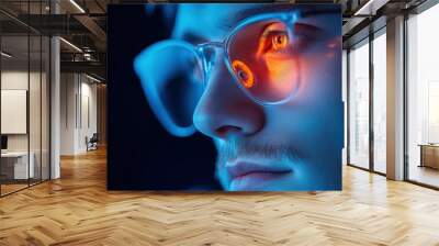 A person working on a computer with blue light filter glasses, showcasing the protection against eye strain and fatigue. Wall mural