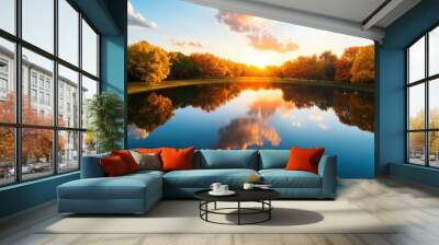 A serene lake reflecting the colors of a sunset sky, showcasing the beauty and tranquility of nature. Wall mural