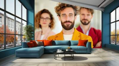 A successful business team posing confidently in a modern office, with a sense of triumph and achievement evident in their expressions. The clean, uncluttered background provides ample copy space. Wall mural