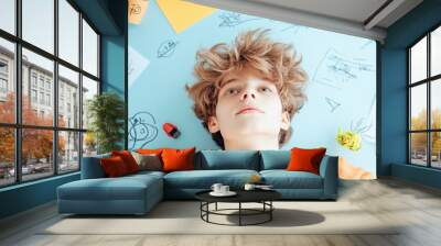 A young entrepreneur working on a business plan, surrounded by notes and sketches, reflecting the passion and drive of a startup founder. Wall mural