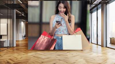 Happy young woman enjoying shopping on vacation. Wall mural