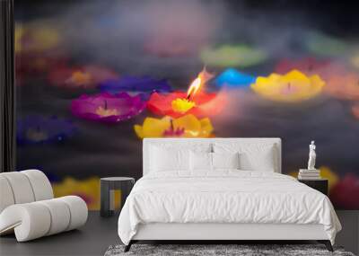 Spiritual inspirational candle light burning floating in the water with smoke. Wall mural