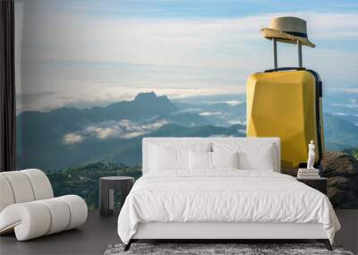 Travel suitcase with hat on the nature of beautiful mountain landscape and mist, relaxing time, holidays, weekend and traveling concept.  Wall mural