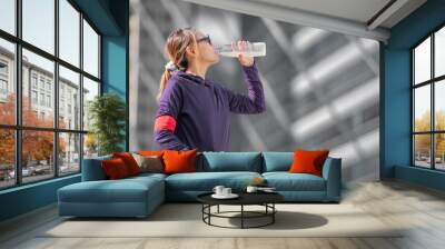 Young sports healthy woman drinking water. Wall mural