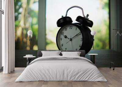 Alarm clock on wooden table background Wall mural