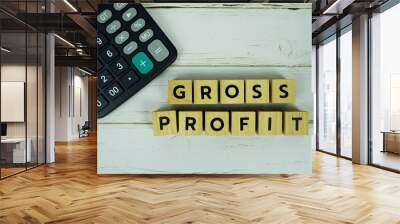 Gross Profit with wooden blocks alphabet letters and calculator on wooden background Wall mural