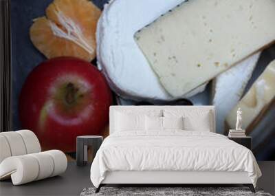 Cheese plate with grapes, fruits and nuts on a dark grey textured background Wall mural