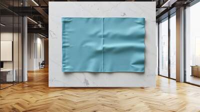 Folded tablecloth at stone or marble surface of table. Top view as panorama of cloth napkin texture background isolated with white shades, png Wall mural