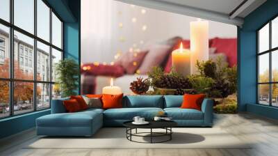 Composition of candles on  white table against the background of sofa at home Wall mural